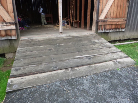 Compacted gravel path transitions to wooden ramp at the barn on the Manson Farmstead